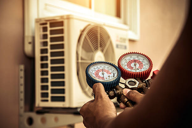 Professional Air Conditioning Service technician working in Van Meter, IA